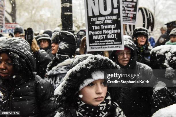 People listen to speakers at a #MeToo rally outside of Trump International Hotel on December 9, 2017 in New York City.