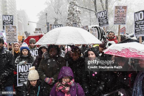 People listen to speakers at a #MeToo rally outside of Trump International Hotel on December 9, 2017 in New York City.