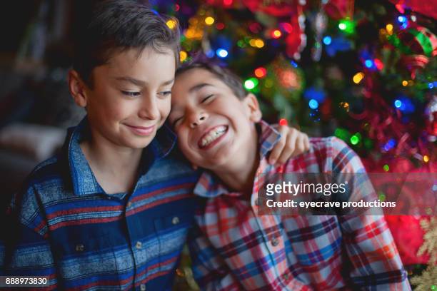 holiday gatherings - young brothers during the holidays - sibling christmas stock pictures, royalty-free photos & images