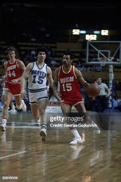 Guard John Lucas, right, of the Houston Rockets brings the ball up the court against guard Ernie DiGregorio of the Buffalo Braves as center Kevin...