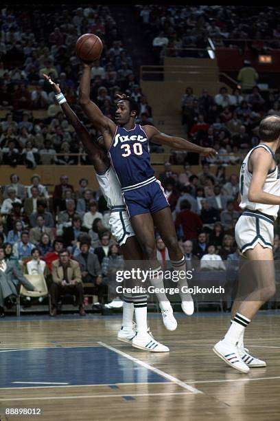 Forward George McGinnis of the Philadelphia Sixers shoots during a National Basketball Association game against the Buffalo Braves at the Memorial...