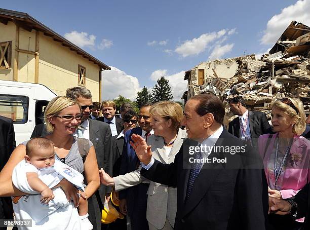 German Chancellor Angela Merkel and Italian Prime Minister Silvio Berlusconi visit quake-ravaged hamlet Onna on July 08, 2009 in Onna, Italy. The...