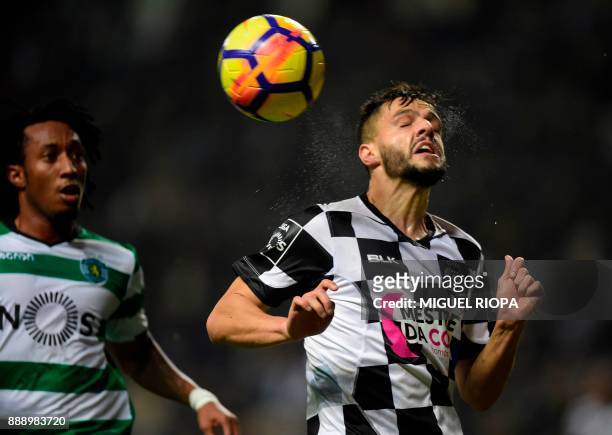 Boavista's Portuguese defender Talocha heads the ball next to Sporting's Portuguese forward Gelson Martins during the Portuguese league football...