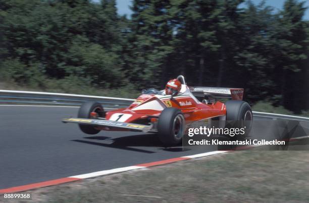 The German Grand Prix; Nürburgring, August 1, 1976. Nikki Lauda flying with is Ferrari 312T at Flugplatz during practice. In the race he had a...