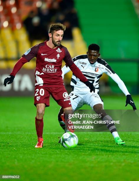 Metz's French defender Julian Palmieri vies for the ball with Rennes' Malian defender Hamari Traore during the French L1 football match between Metz...