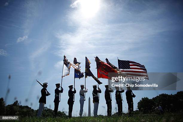 Military color guard prepares to march into a ceremony commemorating the 50th anniversary of the first two American combat casualties of the Vitenam...