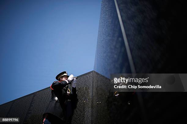 Wentworth Military Academy Cadet Capt. Joel Fowler makes a photograph of the first two names on the Vietname Veterans Memorial, or The Wall, during a...