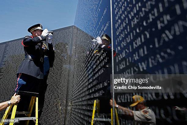 Wentworth Military Academy Cadet Capt. Joel Fowler makes a photograph of the first two names on the Vietname Veterans Memorial, or The Wall, during a...