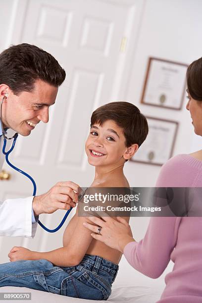 young boy getting check up at the doctor - take care new york screening stockfoto's en -beelden