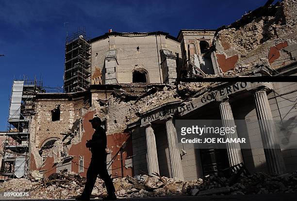 Policemen walks by the Palazo de Governo in downtown L'Aquila prior to the visit by Italian Prime Minister Silvio Berlusconi and US President Barack...