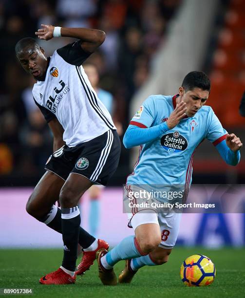 Geoffrey Kondogbia of Valencia competes for the ball with Pablo Hernandez of Celta de Vigo during the La Liga match between Valencia and Celta de...