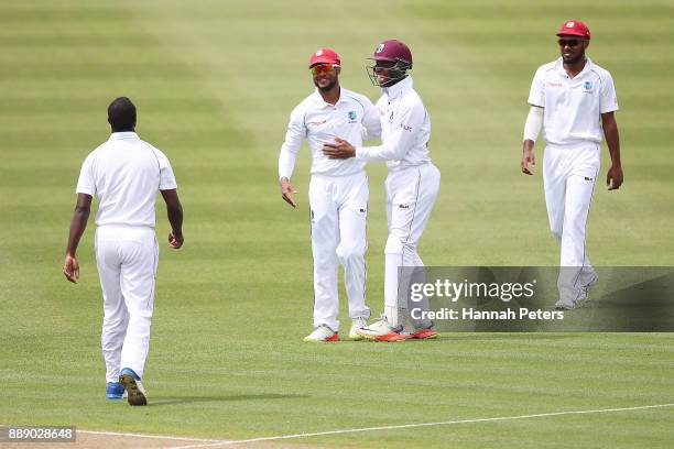 Kemar Roach celebrates with Shai Hope and the west Indies team after claiming the wicket of Neil Wagner of New Zealand during day two of the Second...