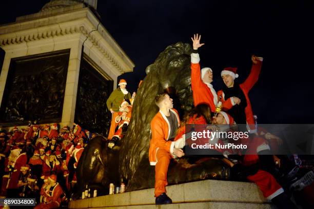 People dressed as Santa Claus gather by Nelson's column durinng Santacon day in London, UK, on 9 December 2017, Thousands of drunken people descend...