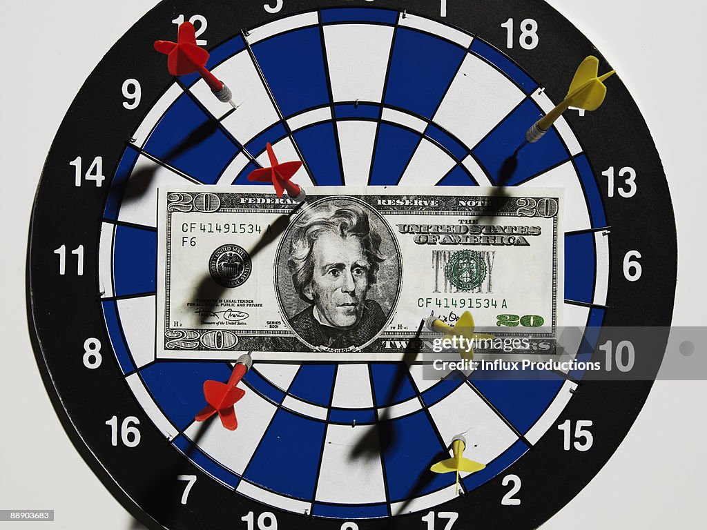 Twenty dollar bill on dartboard