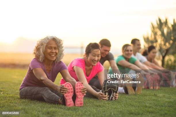 fitness class stretching - baby boomer stock pictures, royalty-free photos & images