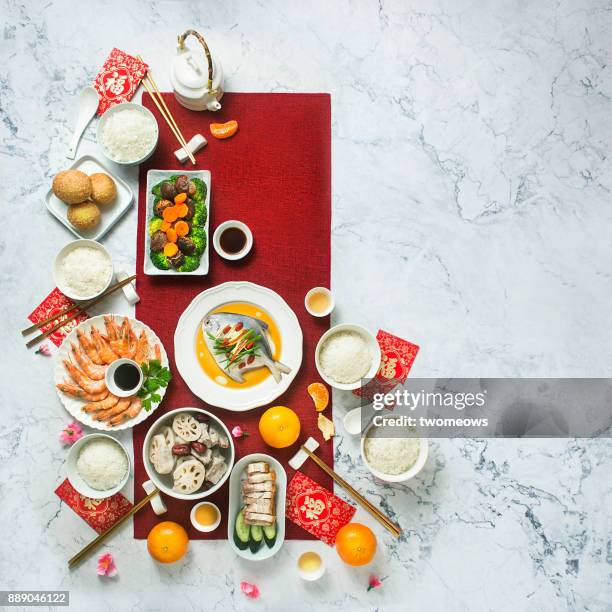 flat lay chinese new year reunion dinner, food and drink. marble top background. - chinese new year food stock pictures, royalty-free photos & images