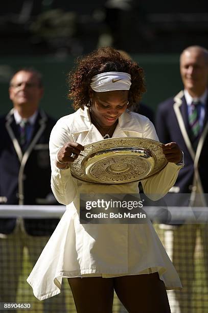 Serena Williams victorious with Rosewater Dish trophy after winning Women's Finals vs USA Venus Williams at All England Club. London, England...