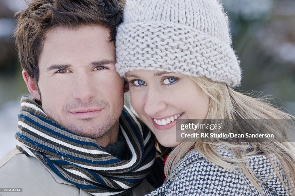 Close up portrait of young couple, winter scene.
