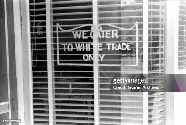 Close-up of a sign on a restaurant window that reads 'We Cater to White Trade Only,' Lancaster, Ohio, 1938.