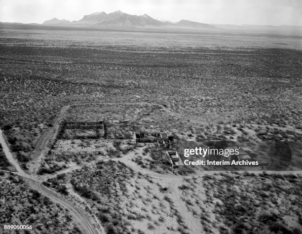 An aerial view of the remains of structures, including the McDonald ranch house, at the White Sands Missile Range, New Mexico, 1968. The San Andreas...