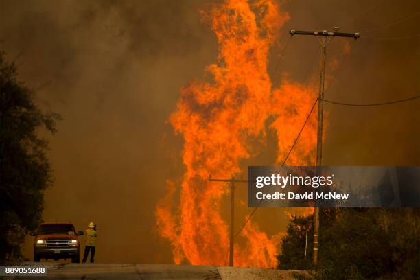 Flames rise as a fire front approaches the Lake Casitas area on December 8, 2017 near Ojai, California. Strong Santa Ana winds have been feeding...