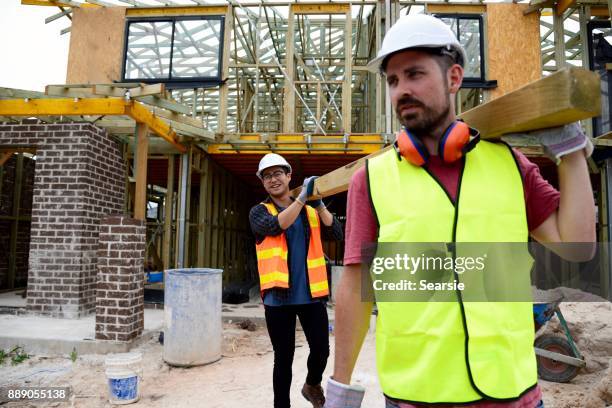 syd112017 diverse construction workers carrying timber - apprentice builder stock pictures, royalty-free photos & images