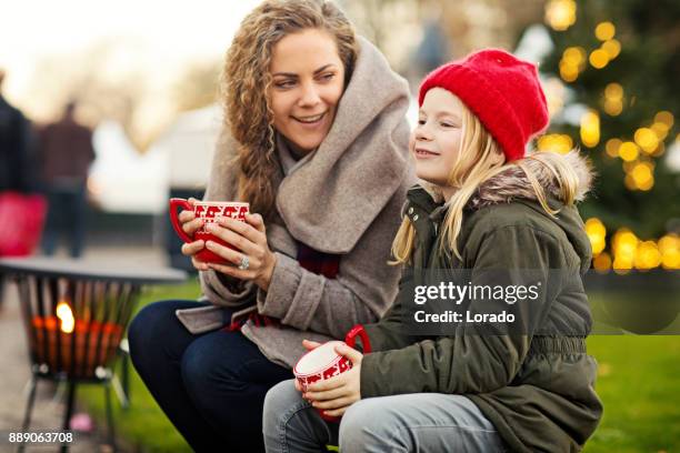 beautiful blonde mother and blonde daughter at winter christmas market - netherlands christmas stock pictures, royalty-free photos & images
