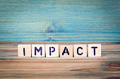 impact - name from wooden letters. Office desk, informative and communication background
