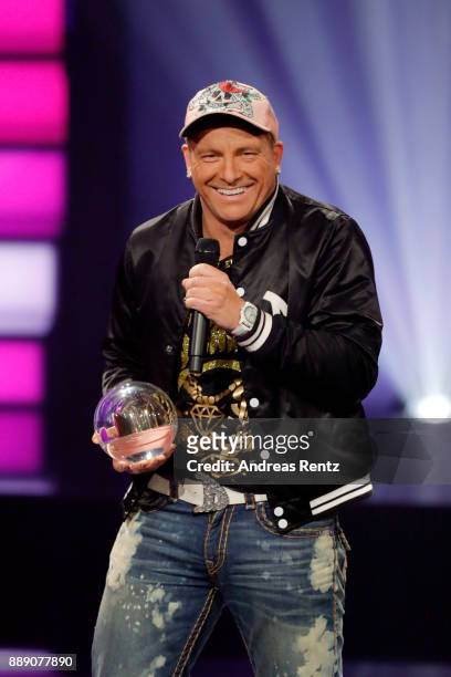 Dennis aus Huerth poses with his award 'Comedy Krone' on stage during the 1Live Krone radio award at Jahrhunderthalle on December 07, 2017 in Bochum,...