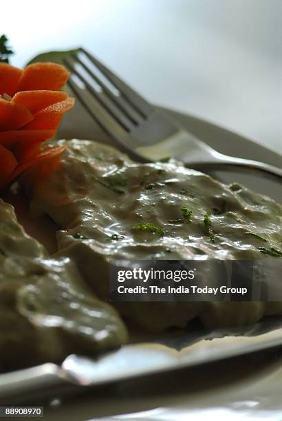 Baked Bekti Fish with Curd and lemon Dressing at Oh Calcutta Restaurant in New Delhi, India