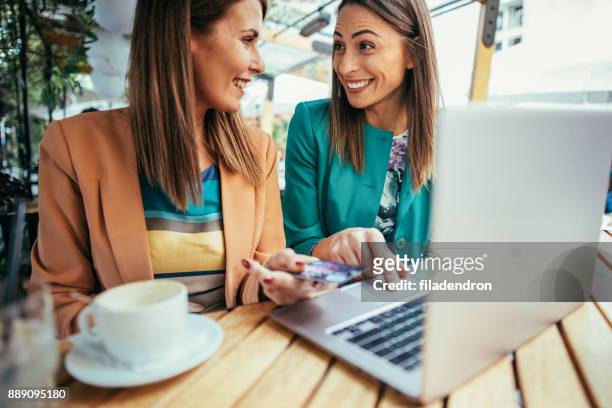 women shopping online - moneytransfer stock pictures, royalty-free photos & images