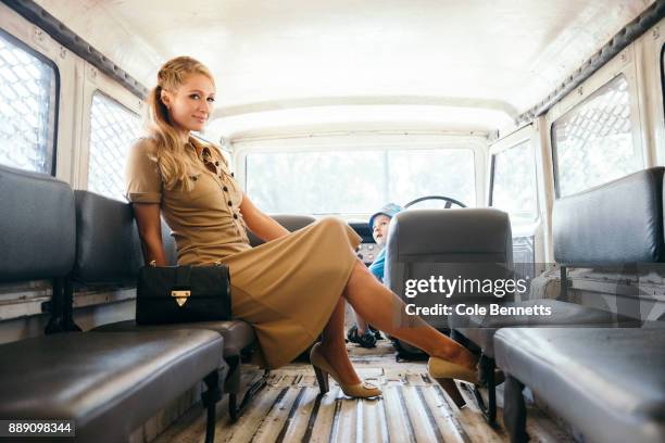 Little boy looks on in awe at Paris Hilton after sneaking into the drivers seat during a photoshoot and promotion visit to Australia to launch her...