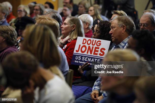 People listen as Democratic Senatorial candidate Doug Jones speaks during a campaign event held at Alabama State University at the John Garrick Hardy...