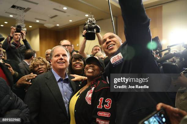 Democratic Senatorial candidate Doug Jones takes a group picture with Sen. Cory Booker and Rep. Terri Sewell and supporters during a campaign event...