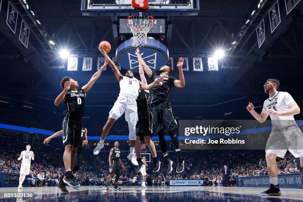 Trevon Bluiett of the Xavier Musketeers drives to the basket against D'Shawn Schwartz and Dallas Walton of the Colorado Buffaloes in the first half...