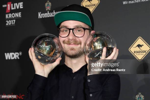 Mark Forster poses with his awards during the 1Live Krone radio award at Jahrhunderthalle on December 07, 2017 in Bochum, Germany.