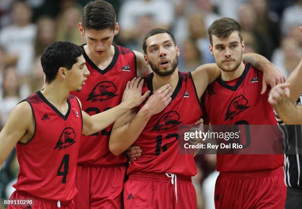 Jadon Cohee of the Southern Utah Thunderbirds walks off the court with his team mates during a time out against the Michigan State Spartans at...