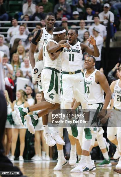 Cassius Winston of the Michigan State Spartans celebrates with his teammates Lourawls Nairn Jr. #11 and Jaren Jackson Jr. #2 of the Michigan State...