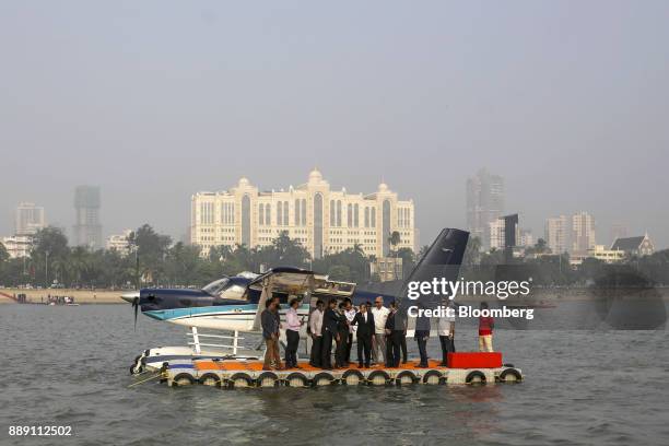 Attendees stand in front of a Quest Aircraft Co. Amphibious Kodiak plane, operated by SpiceJet, during a demonstration flight event in Mumbai, India,...