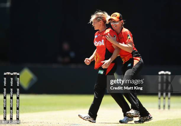 Katherine Brunt of the Scorchers celebrates with Lauren Ebsary after taking the wicket of Beth Mooney of the Heat during the Women's Big Bash League...