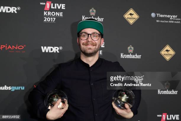 Mark Forster poses with his awards during the 1Live Krone radio award at Jahrhunderthalle on December 07, 2017 in Bochum, Germany.