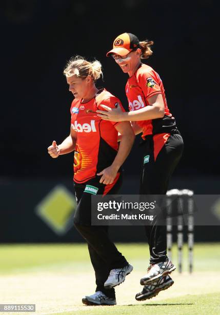 Katherine Brunt of the Scorchers celebrates with Lauren Ebsary after taking the wicket of Beth Mooney of the Heat during the Women's Big Bash League...