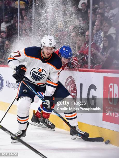Oscar Klefbom of the Edmonton Oilers skates the puck against Alex Galchenyuk of the Montreal Canadiens during the NHL game at the Bell Centre on...