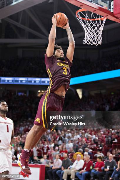 Jordan Murphy of the Minnesota Golden Gophers goes up for a dunk during a game against the Arkansas Razorbacks at Bud Walton Arena on December 9,...