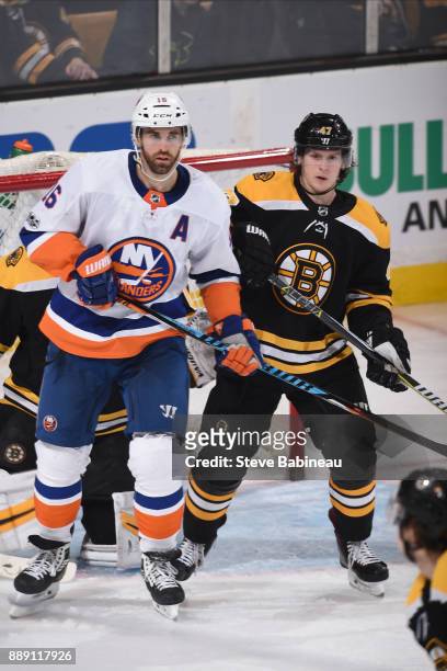 Torey Krug of the Boston Bruins against Andrew Ladd of the New York Islanders at the TD Garden on December 9, 2017 in Boston, Massachusetts.