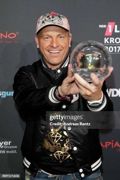 Dennis aus Huerth poses with his award during the 1Live Krone radio award at Jahrhunderthalle on December 07, 2017 in Bochum, Germany.