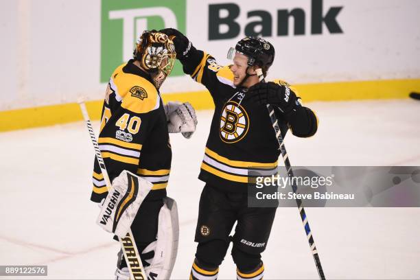 Tuukka Rask and David Pastrnak of the Boston Bruins celebrate a win against the New York Islanders at the TD Garden on December 9, 2017 in Boston,...