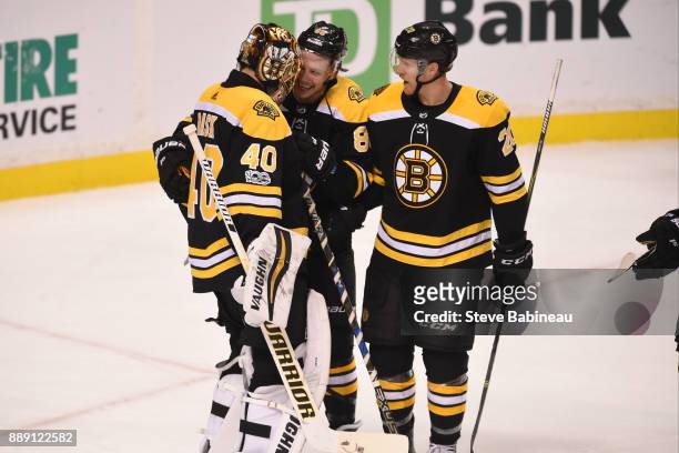 Tuukka Rask, David Pastrnak and Riley Nash of the Boston Bruins celebrate a win against the New York Islanders at the TD Garden on December 9, 2017...