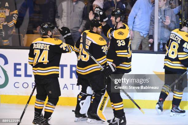 Jake DeBrusk and Zdeno Chara of the Boston Bruins celebrate a win against the New York Islanders at the TD Garden on December 9, 2017 in Boston,...