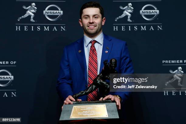 Baker Mayfield, quarterback of the Oklahoma Sooners, poses for the media after the 2017 Heisman Trophy Presentation at the Marriott Marquis December...